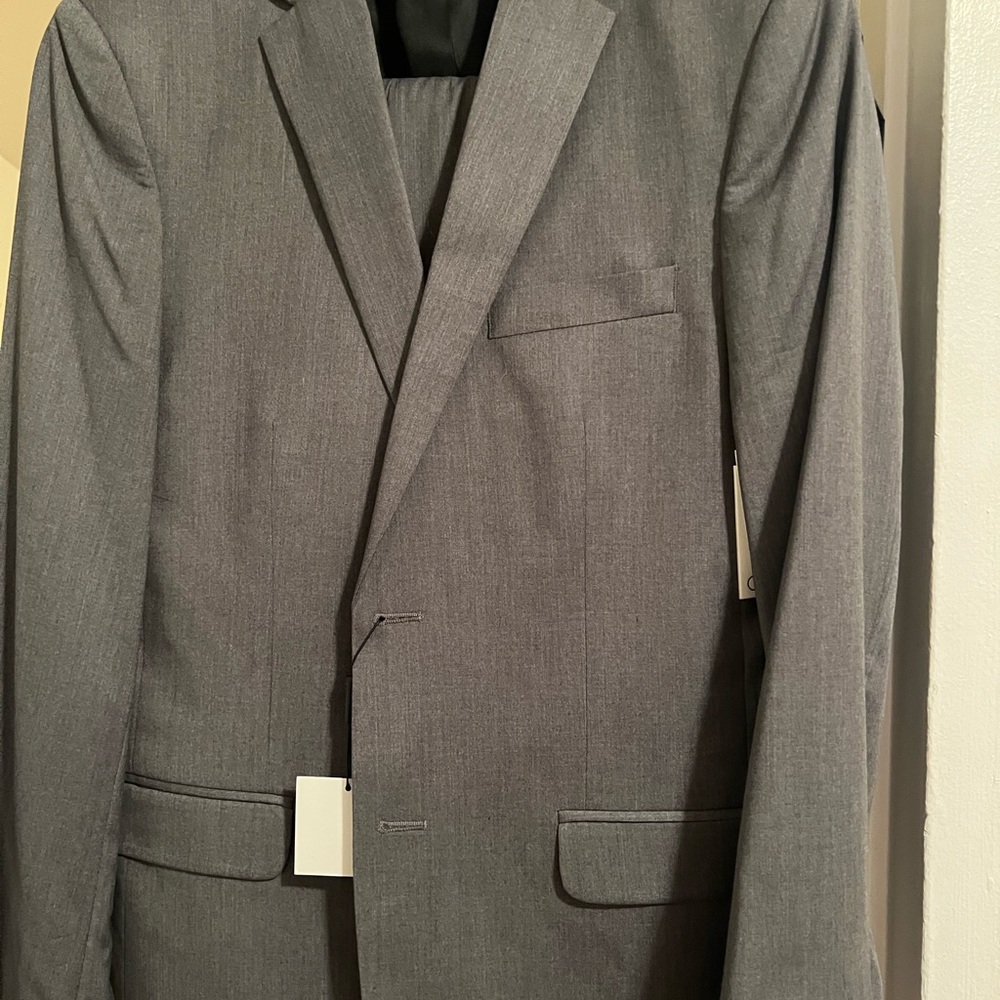 Light grey Calvin Klein slim fit suit 38R and 32W 32L trouser. Brand new w tags